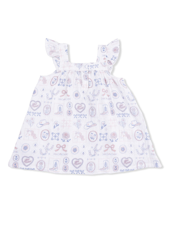 White sleeveless dress with ruffled straps, featuring a colorful western-themed print.