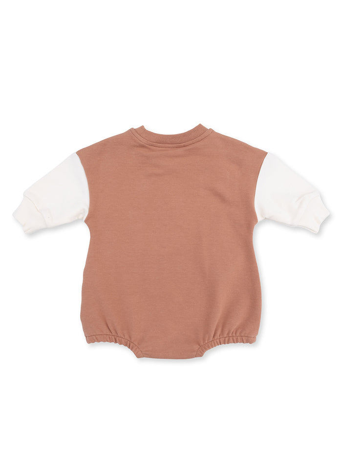 Back view of a brown and white infant onesie with long sleeves and a rounded neckline.