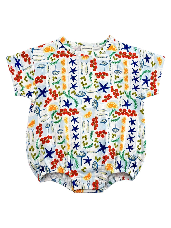 Colorful baby romper featuring fruit, starfish, and beach-themed patterns on a white background.