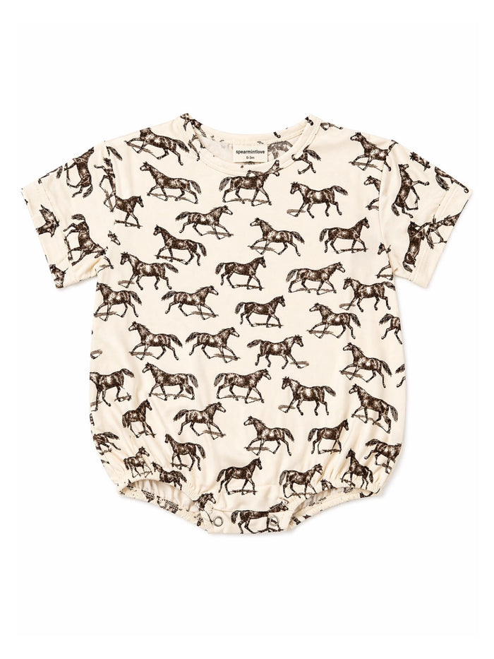 Light cream baby onesie featuring a pattern of galloping horses in brown. Soft, comfortable fabric for infants.