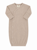 Light beige newborn sleep sack with ribbed texture and snap buttons, designed for comfort and ease of use.