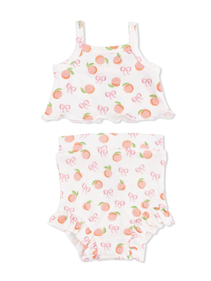 Two-piece kids' outfit featuring a peach and bow pattern on a white background. Ideal for warm weather.