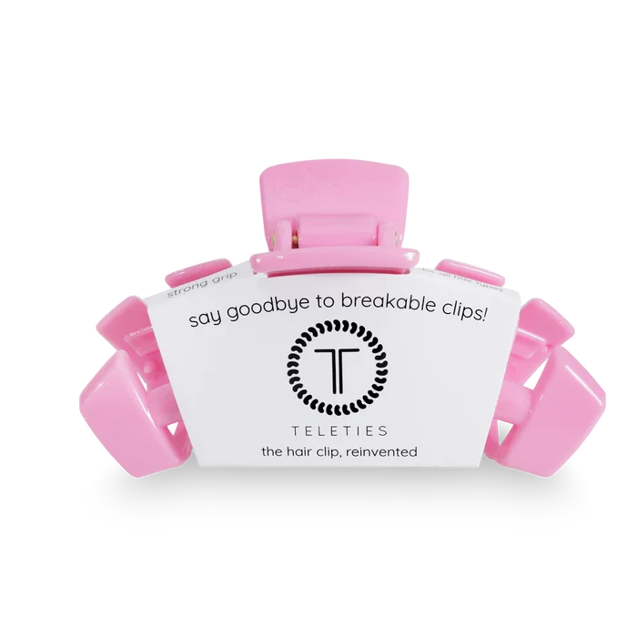 Pink hair clip with a white label displaying 'Teleties' on a transparent background