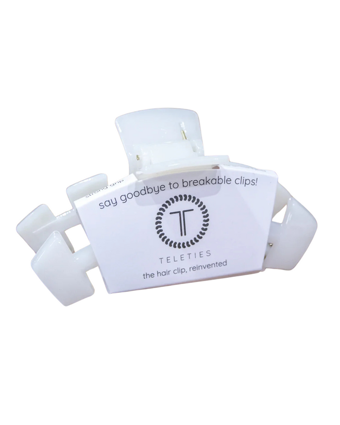 A pink Teleties large hair clip with packaging that reads 'say goodbye to breakable clips! Teleties the hair clip, reinvented'.
