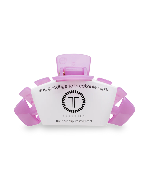 A pink Teleties large hair clip with packaging that reads 'say goodbye to breakable clips! Teleties the hair clip, reinvented'.