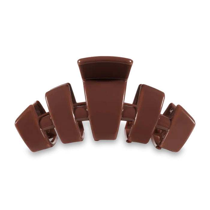 A pink Teleties large hair clip with packaging that reads 'say goodbye to breakable clips! Teleties the hair clip, reinvented'.