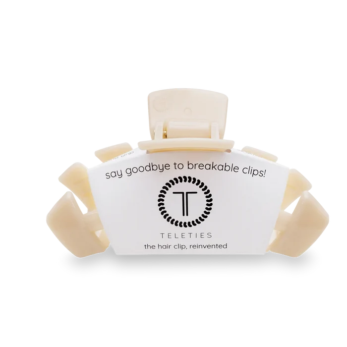 A pink Teleties large hair clip with packaging that reads 'say goodbye to breakable clips! Teleties the hair clip, reinvented'.
