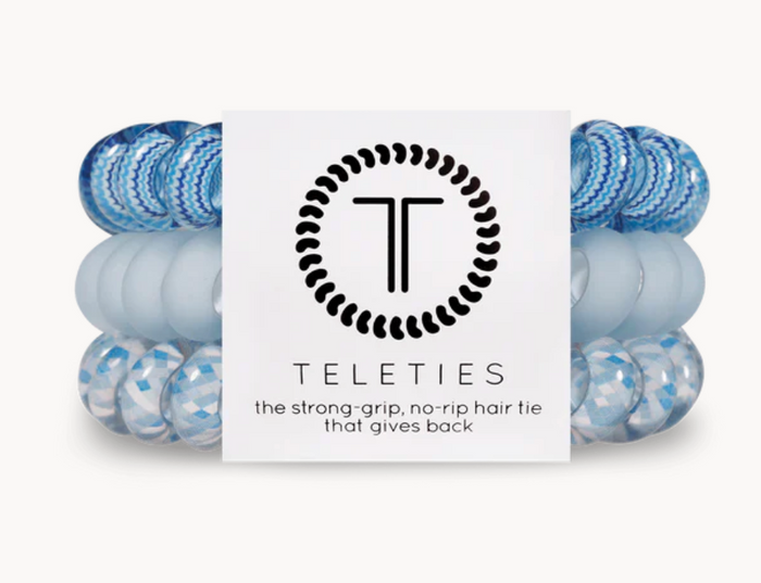 A pack of three blue Teleties hair ties with a logo.