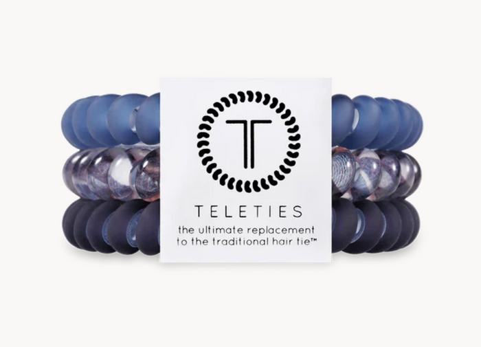 A pack of three blue Teleties hair ties with a logo.