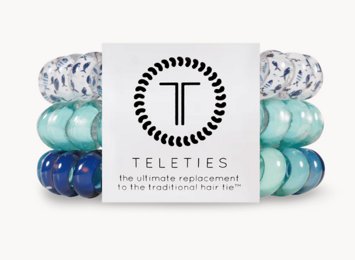 A pack of three blue Teleties hair ties with a logo.