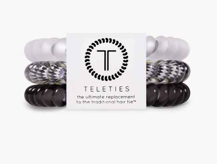A pack of three Teleties hair ties with a logo, colors white, black and patterned