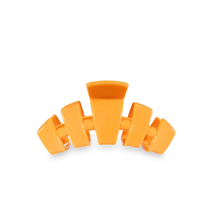 Orange hair clip with a label 'Teleties' on a white background