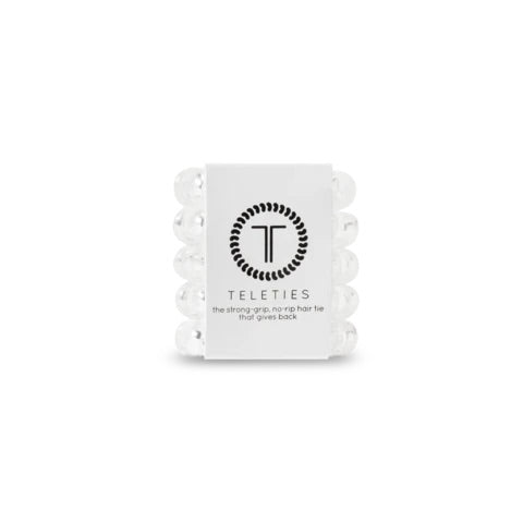 Stack of white hair ties with a white label featuring 'Teleties' branding on a white background.