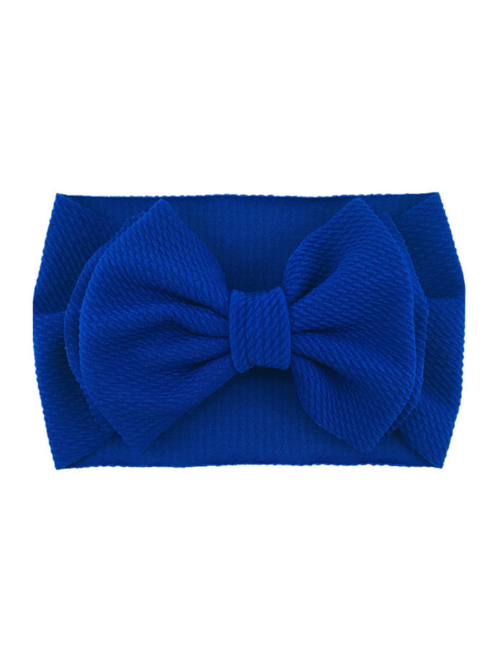 Bright blue headband with a large textured bow at the front.