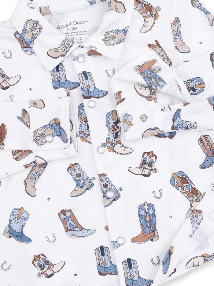 White shirt featuring a playful pattern of colorful cowboy boots and horseshoes, designed for infants.