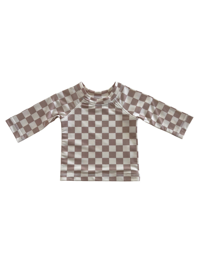 Brown and cream checkered long-sleeve children's swim shirt on a white background.