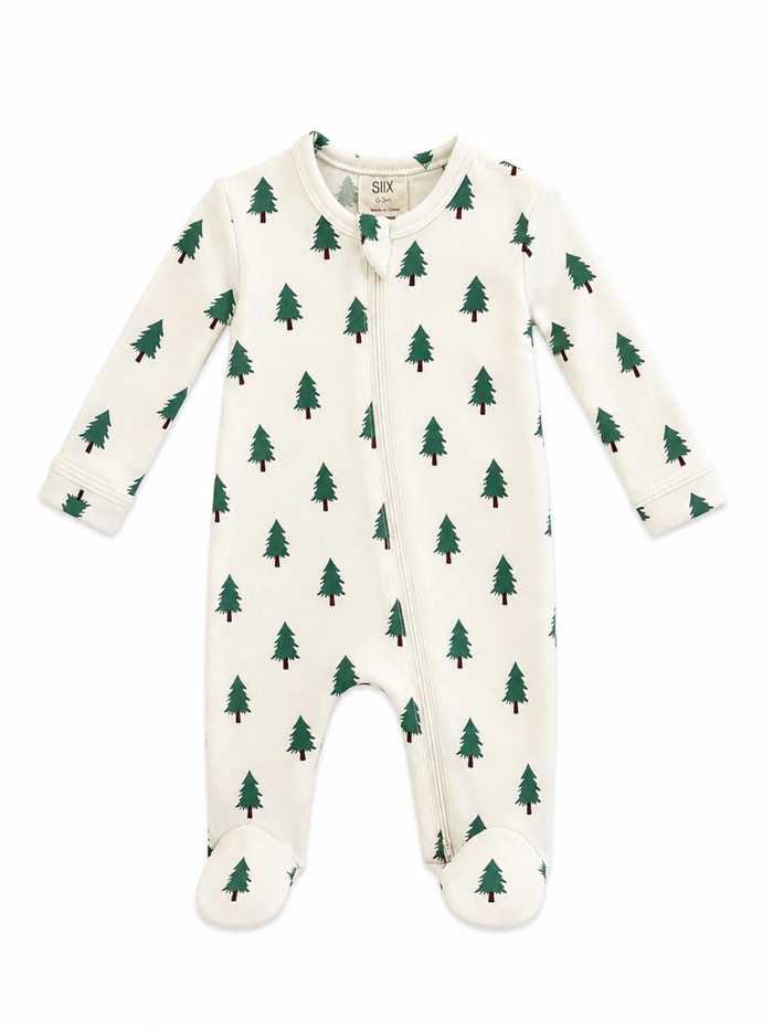 White baby onesie with green trees pattern, featuring a front zipper and footed legs for warmth and comfort.