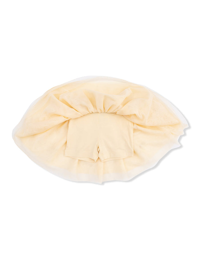 Light yellow tutu skirt with shorts underneath, showcasing a layered design on a white background.