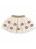 Cream-colored tutu skirt with football patterns and gold bows along the hem. Perfect for sports-themed occasions.