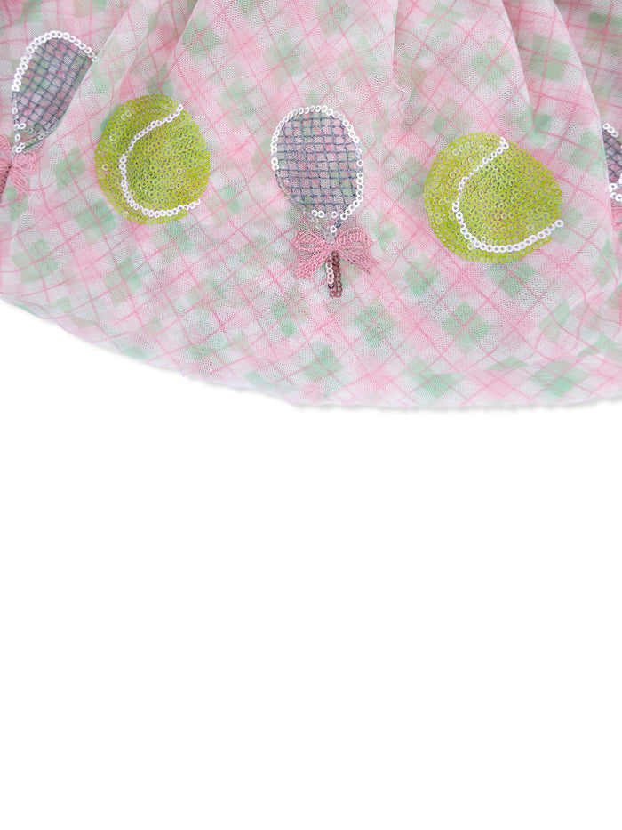 Pink plaid fabric with sequined tennis rackets and balls, creating a playful design.