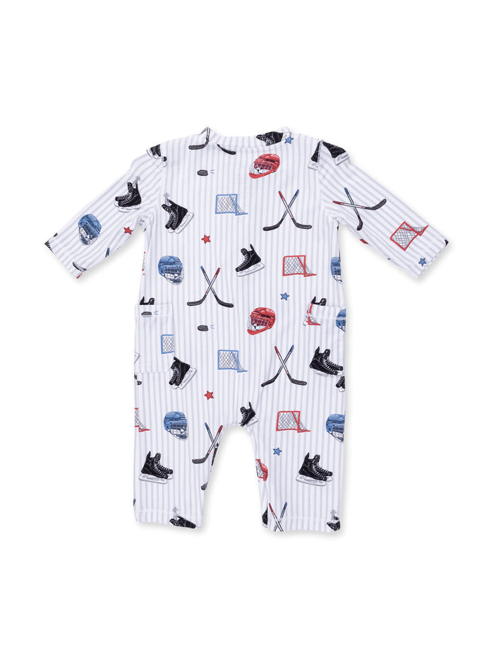 Hockey-themed baby onesie with helmets, sticks, and pucks on a striped background.