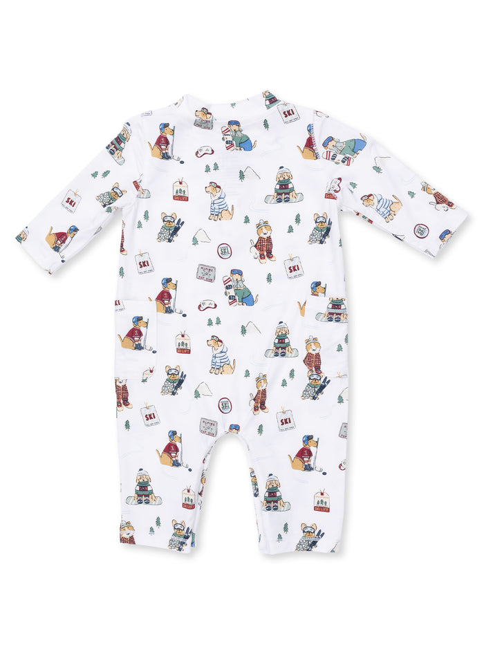 White baby onesie with playful dog illustrations engaging in winter activities like skiing and snowball fighting.