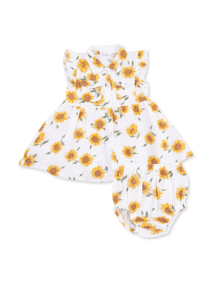 White dress with sunflower print and ruffles, paired with matching bloomers for infants.