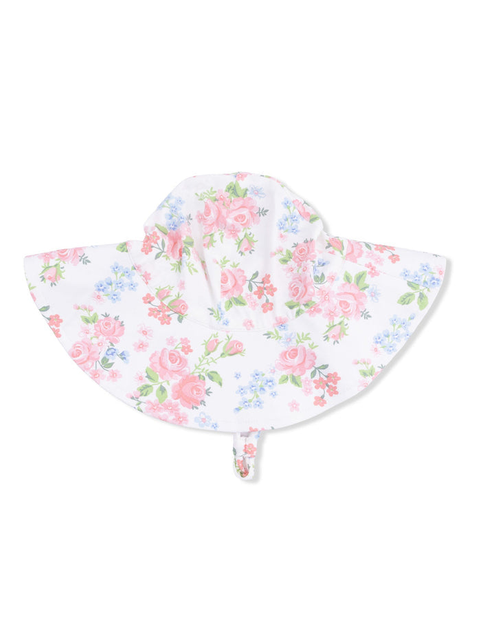 Floral sun hat with pink roses and blue flowers on a white background, featuring a wide brim and tie strap.