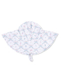 Children's sun hat with a playful pattern of ribbons, trophies, and flags on a light background.