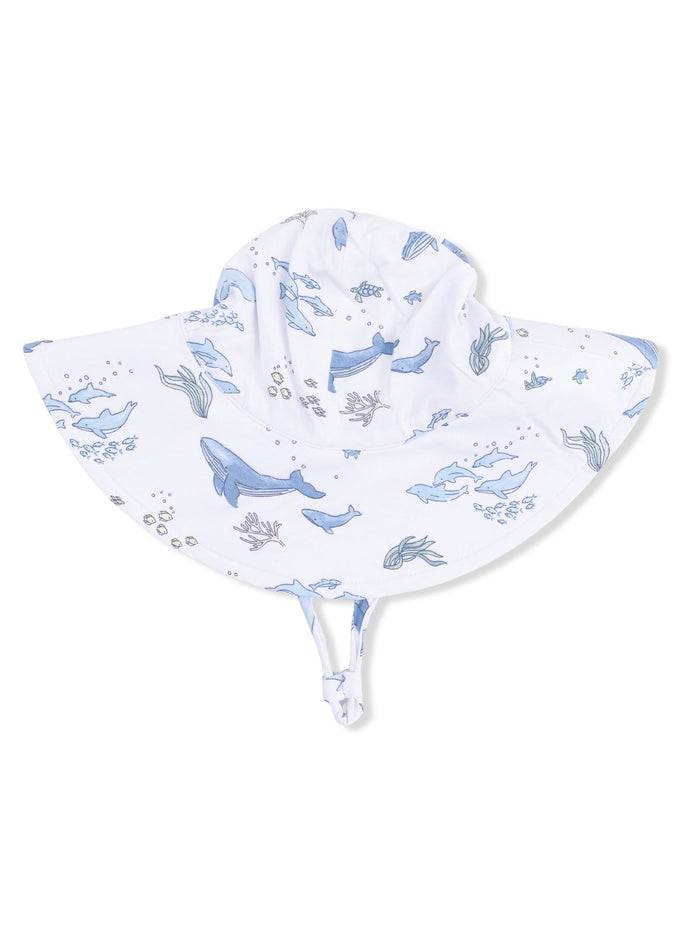 White sun hat with blue whale and ocean-themed patterns, featuring a wide brim and adjustable chin straps.