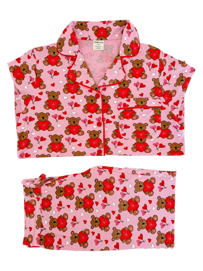 Pink pajama set featuring teddy bears and hearts, perfect for cozy sleepwear.
